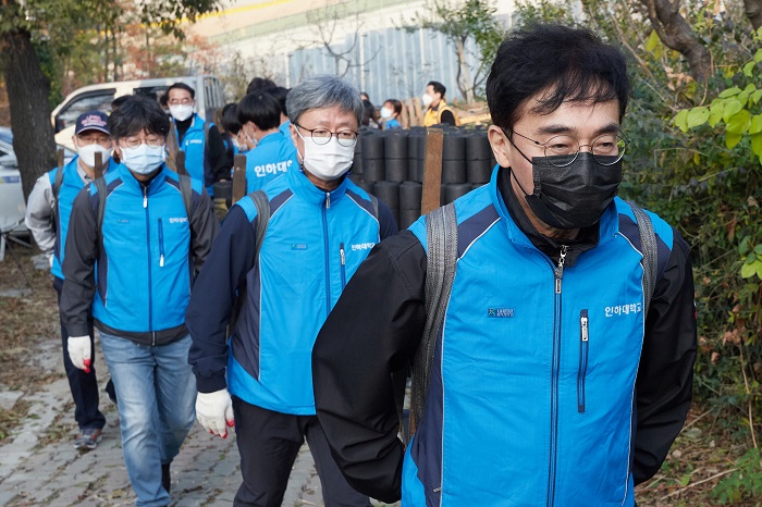 13일 인하대 조명우 총장을 비롯한 학생, 교직원들이 학익동 일대 이웃 주민들에게 연탄나눔봉사를 하고 있다.